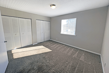 Apartment bedroom with large closets and natural light in New Bern, NC